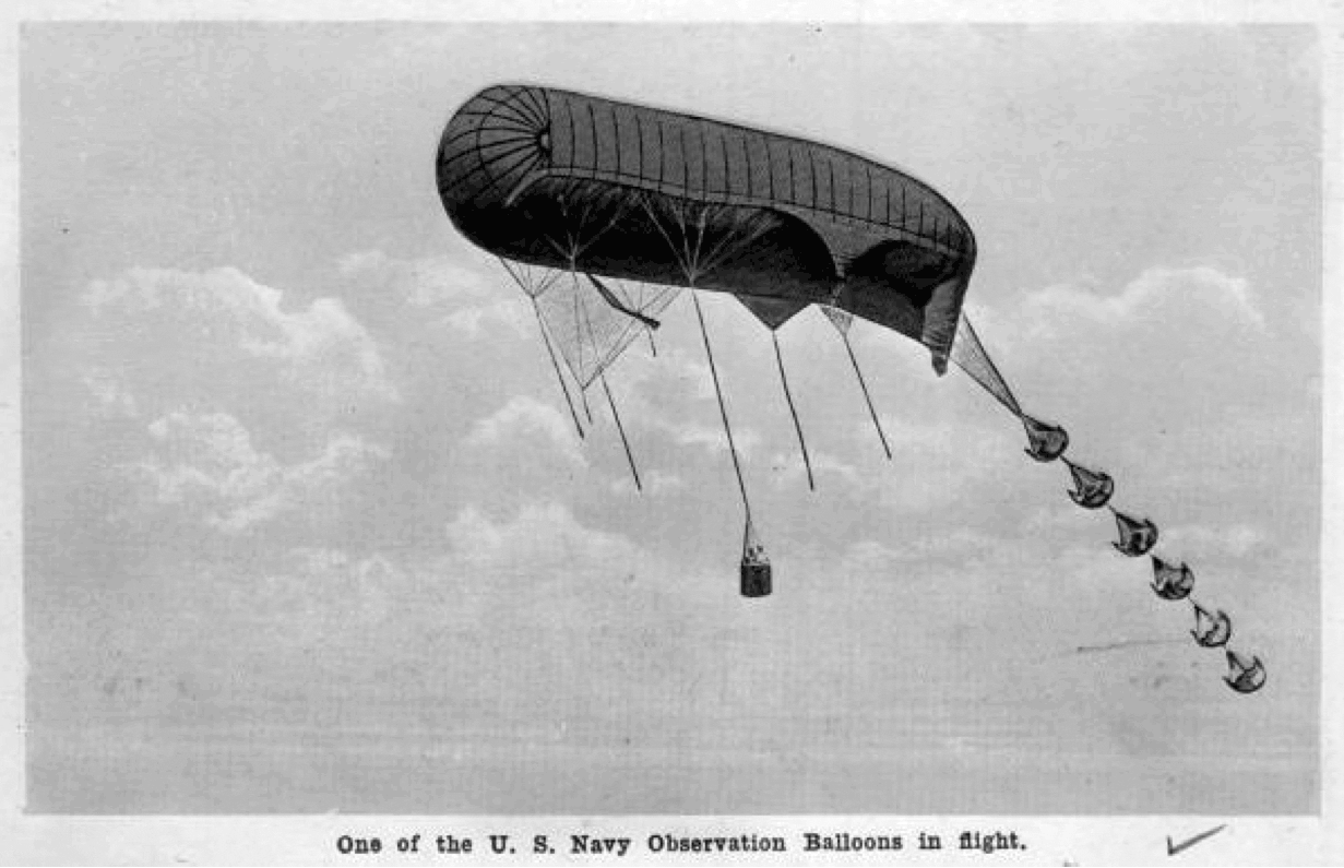black and white photograph of a dirigible against the sky